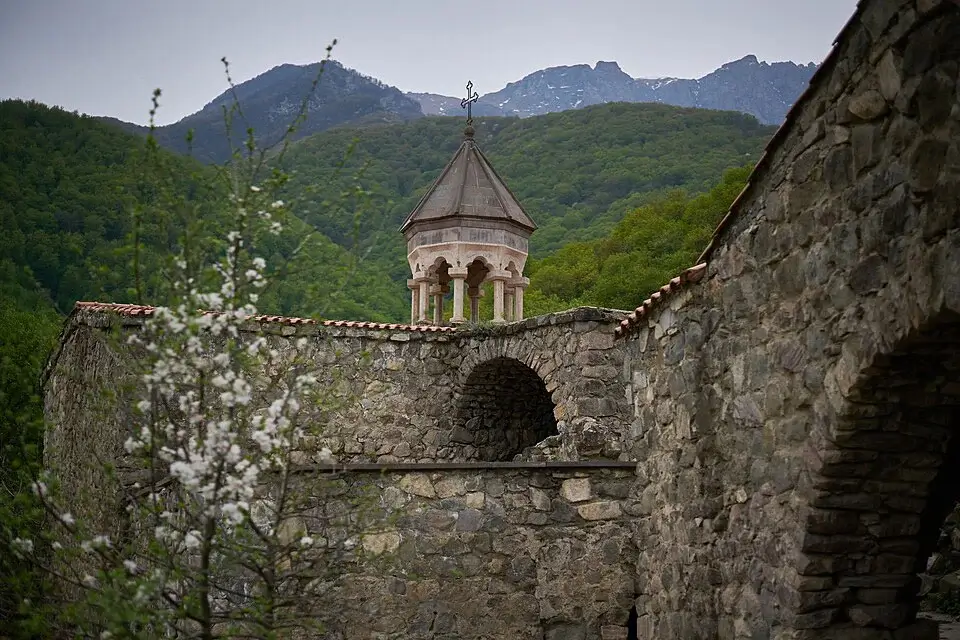 Stone walls and chapel of Halidzor Fortress with Syunik mountains in the background