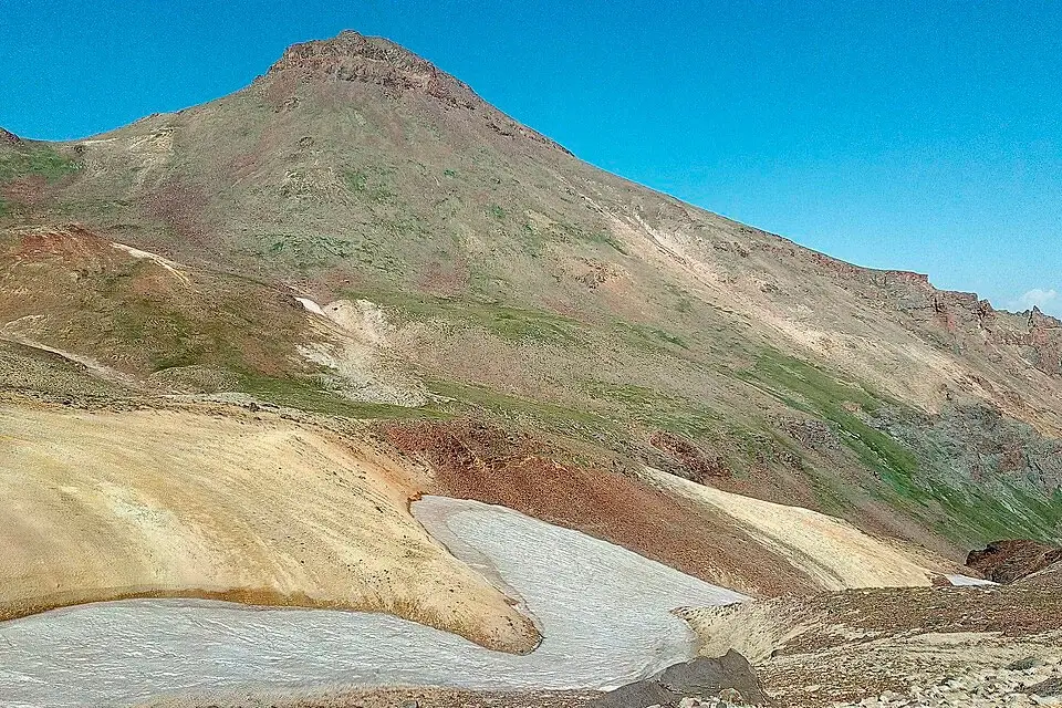 Volcanic crater of Mount Aragats with summer snow patches