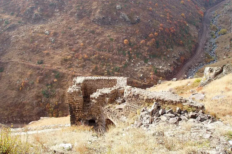 Ruined structures and mountain slope below Amberd Fortress